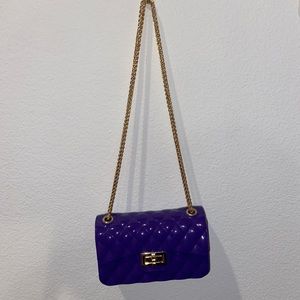 Purple crossbody or shoulder bag with gold hardware